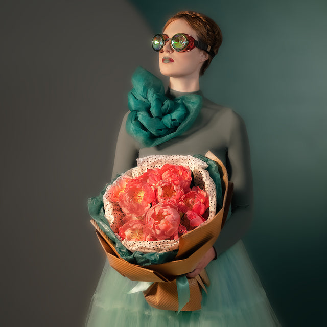Peonies bouquet in the arms of a girl