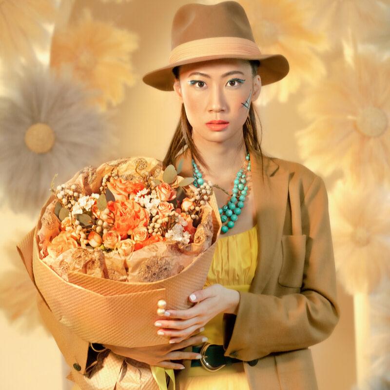 Orange and white bouquet in the arms of a girl