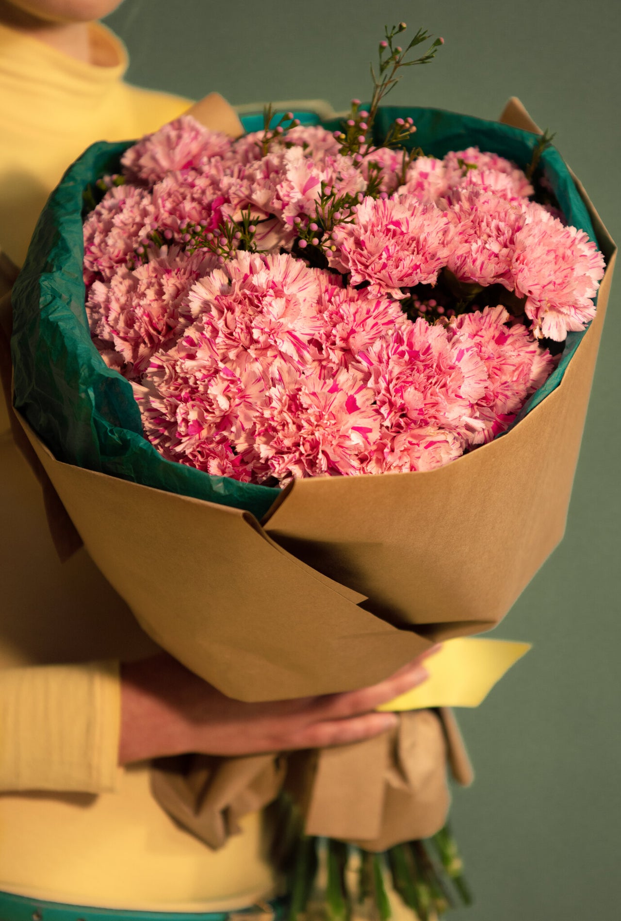 Pink carnations bouquet wrapped in Kraft paper