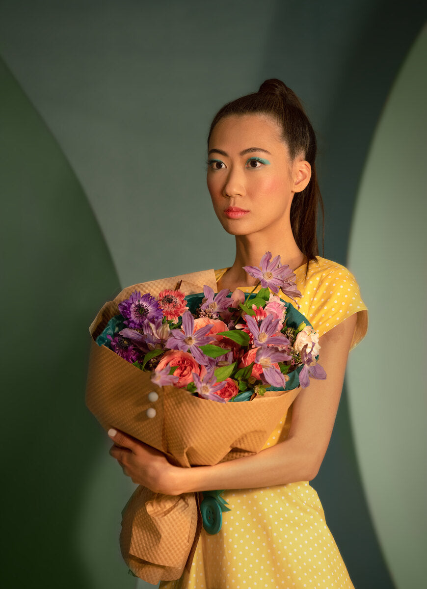 Pink and purple bouquet in the arms of a girl