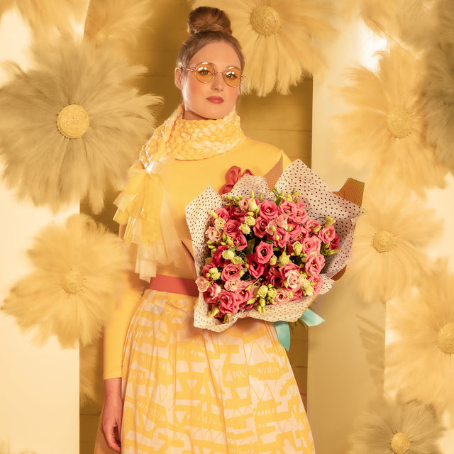 Lisianthus bouquet in the arms of a girl in yellow