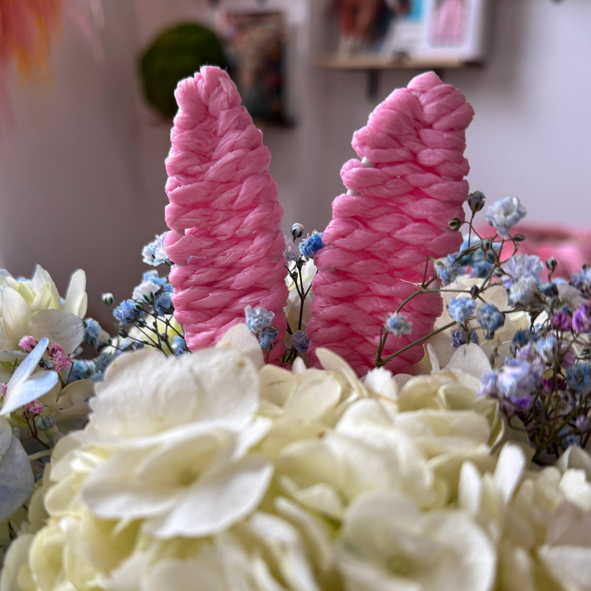 Easter pink bunny ears with fresh flowers.