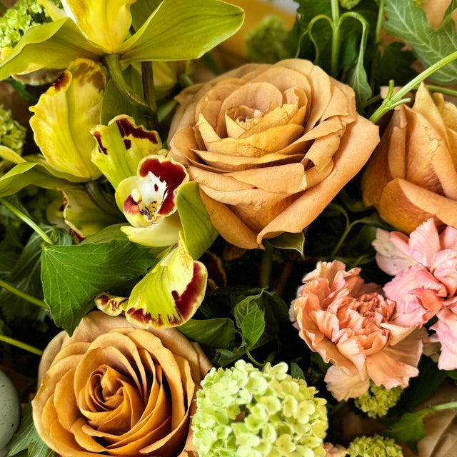 Green Easter floral centerpiece with fresh blooms.