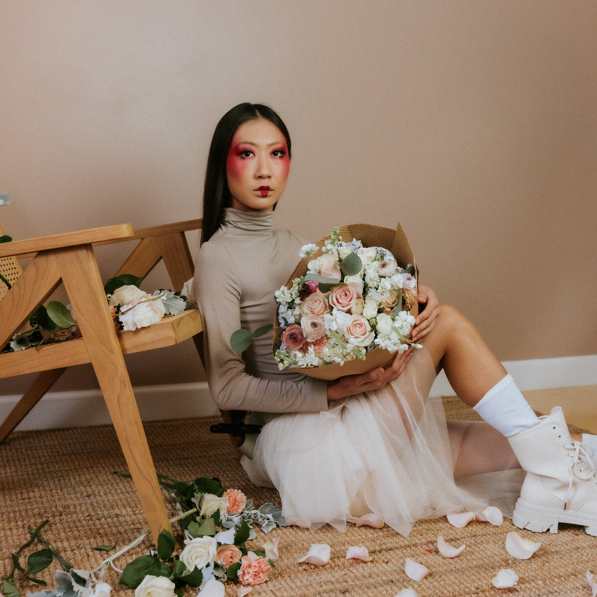 Bouquet of light shades of flowers in the arms of a girl
