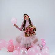 Pink bouquet in the arms of a girl in pink