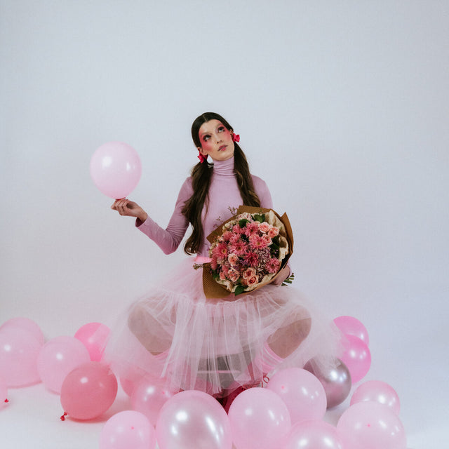 Pink bouquet in the arms of a girl in pink