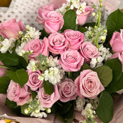 Pink roses and white stock flowers  in the bouquet.