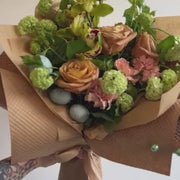 Green Easter floral centerpiece with fresh blooms