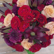 Video showcasing a fall bouquet in a Dijon-colored vase, highlighting the rich deep red colors and textures  and captures the bouquet from various angles, emphasizing its autumnal beauty.