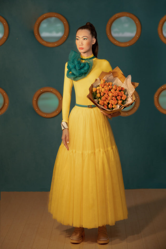 Bouquet of tulips in the arms of a girl in yellow
