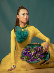 Elegant bouquet of blue irises, purple thistle, and a succulent, beautifully wrapped in eco-friendly kraft paper and green tissue. A harmonious mix of bold colors of the flowers and sustainable materials