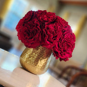 Red rose centerpiece in a golden vase