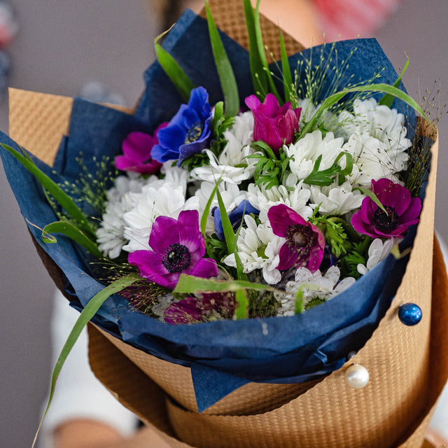 Red, white, and blue 4th of July bouquet with magenta anemones and grass accents