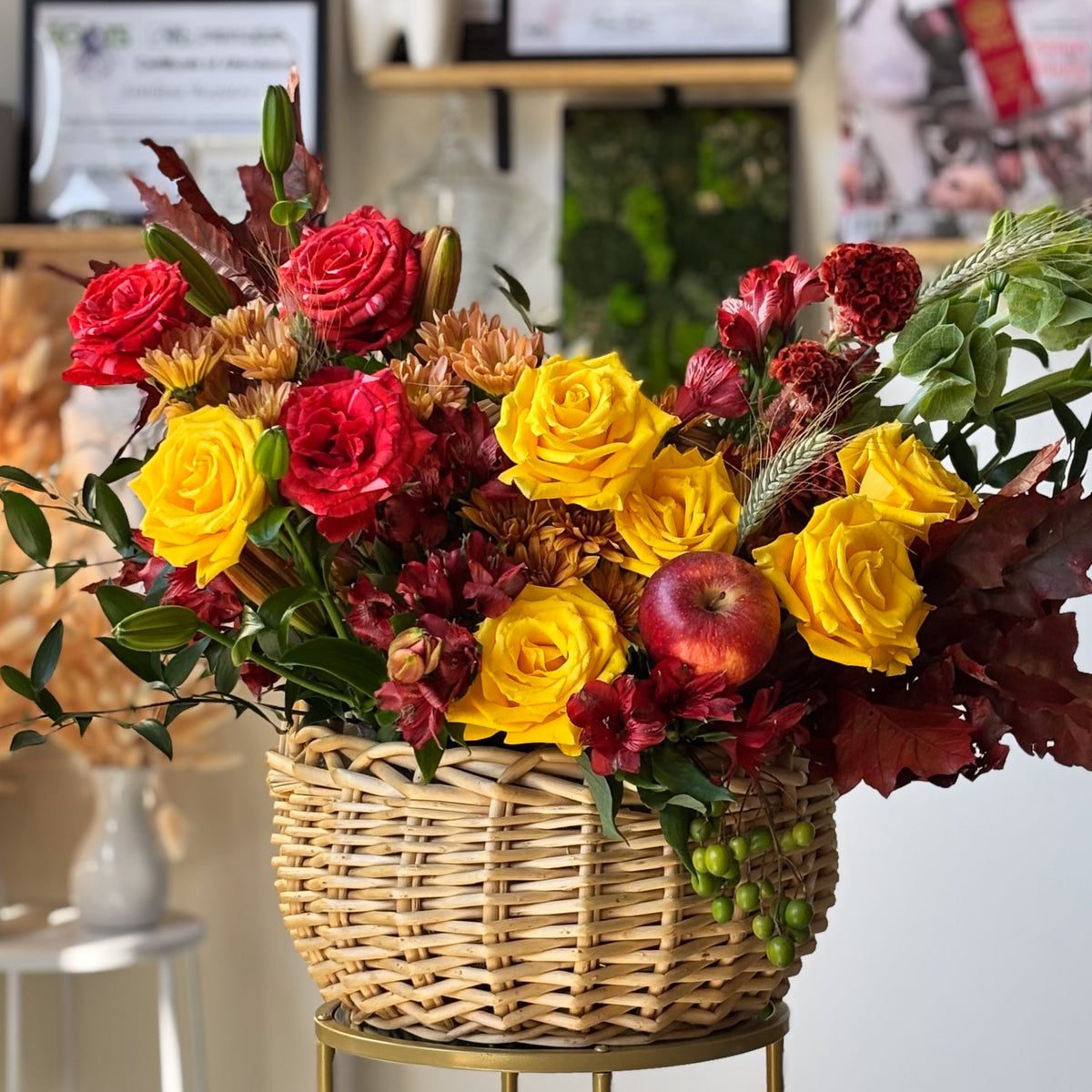 Amber Kisses fall flower basket with yellow, red, and coral roses, chrysanthemums, and decorative apples