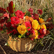 Autumn flower basket with yellow and red roses, seasonal chrysanthemums, and burgundy foliage