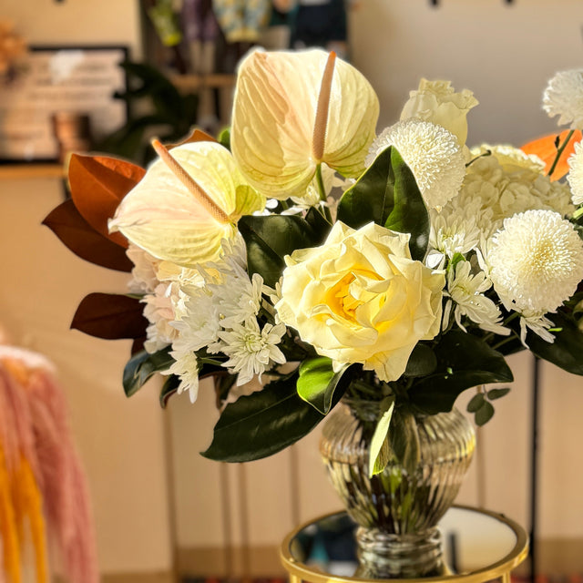 Elegant Winter Grace white floral centerpiece styled for a dining table, perfect for Thanksgiving or Christmas celebrations.