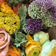 A detailed close-up of a vibrant, fall-colored bouquet.