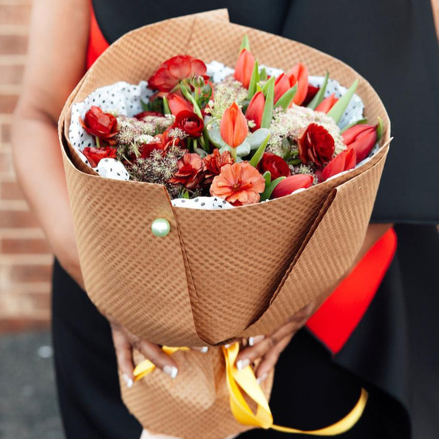 Red bouquet wrapped in Kraft paper