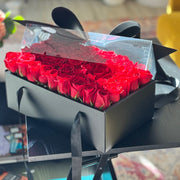 Black flower box filled with premium red roses for Valentine’s Day