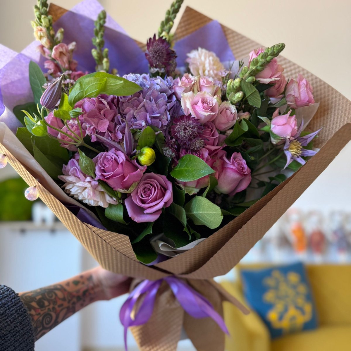 Beautiful bouquet of lavender and soft pink flowers, including hydrangea, roses, clematis.