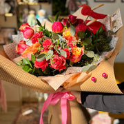 Bouquet of flowers with a pink ribbon in a blurred indoor setting