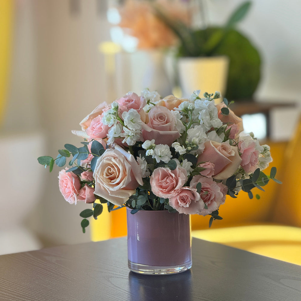 Elegant pink floral centerpiece with spray roses and white stock