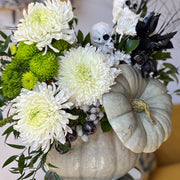 Ghostly Garden pumpkin centerpiece with white and green mums, ruscus, berries, and textured greenery