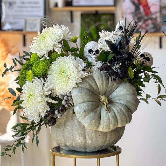 Ghostly Garden Halloween arrangement with white and green chrysanthemums in a gray-green pumpkin