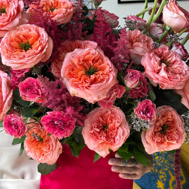 Romantic bouquet with Expression roses, garden roses, spray roses, astilbe, and cascading amaranthus.