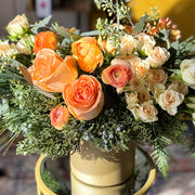 Holiday floral centerpiece in coral and cream tones designed by a Springfield VA florist