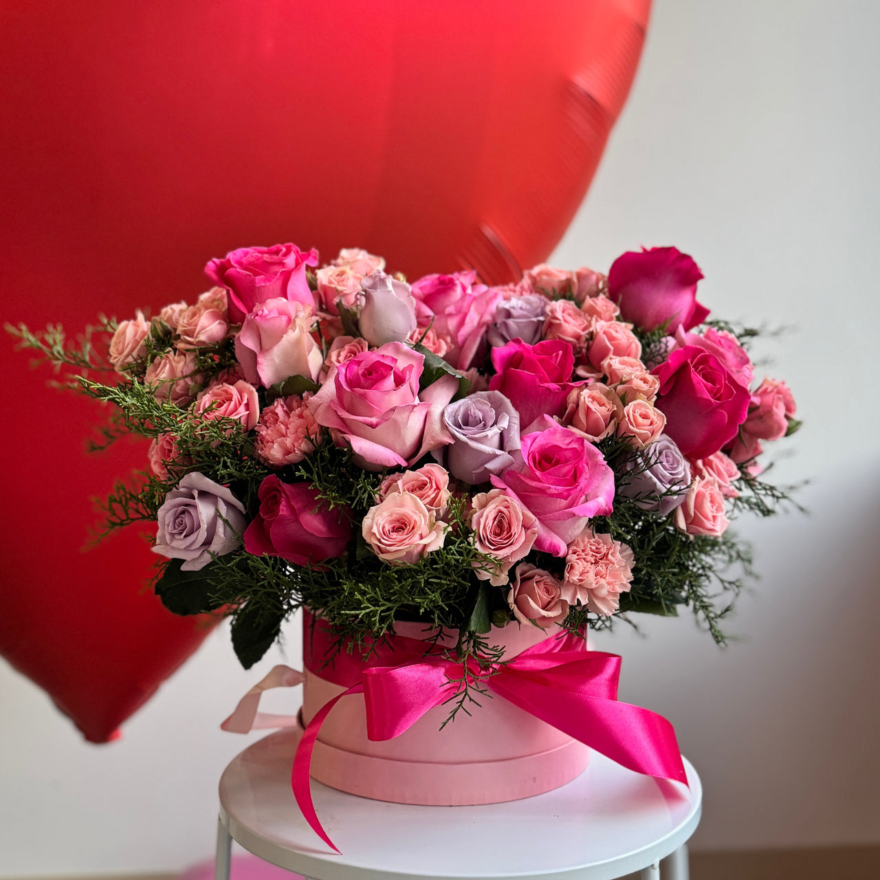 arrangement with pink roses and spray roses