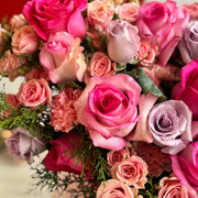 view of individual flowers in arrangement with pink roses and spray roses