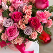 close up view of arrangement with pink roses and spray roses