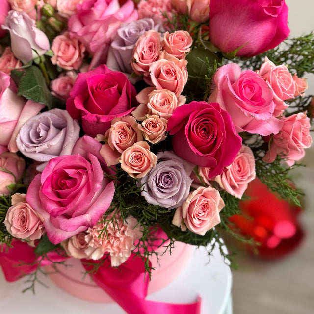 close up view of arrangement with pink roses and spray roses