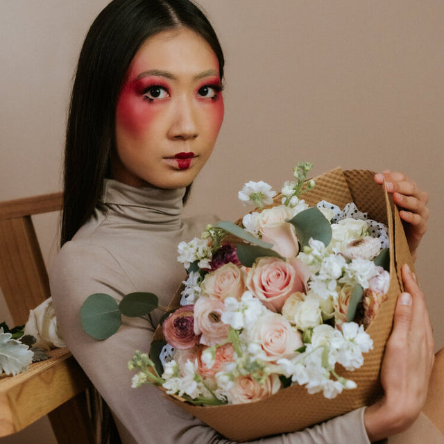 White and pink bouquet held by a girl