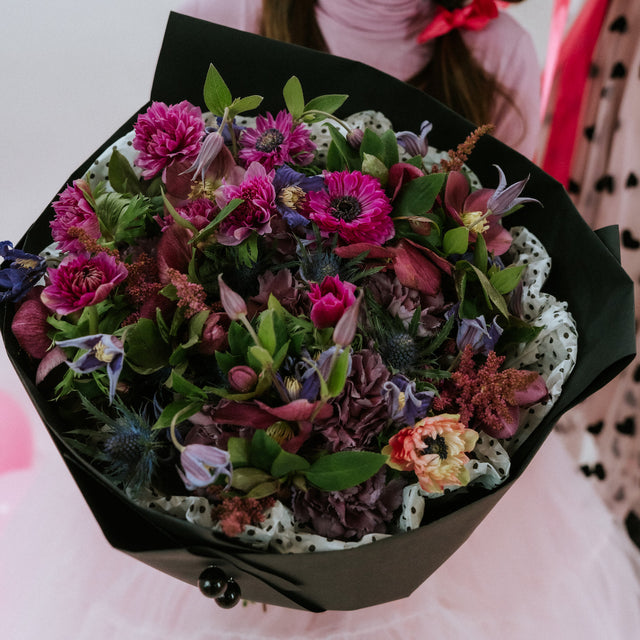 Bouquet of Darker shades of flowers in black wrapping paper