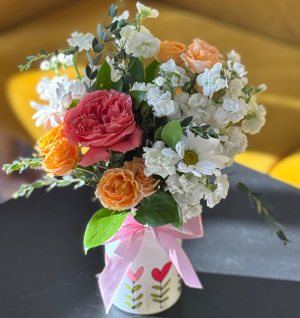 Love Jar flower arrangement with roses, carnations, mums, and stock in a heart-patterned ceramic jar