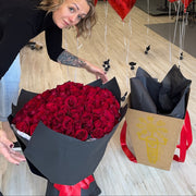 Luxury Valentine’s Day bouquet of one hundred red roses in black wrap