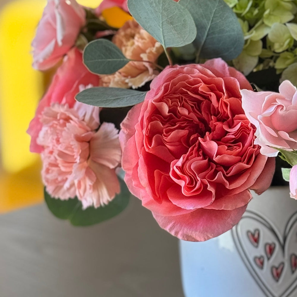 Modern Valentine’s flowers with pink roses, blue hydrangea, and silver dollar eucalyptus
