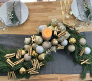 Modern festive centerpiece with pine greenery and space for a candle, styled for an elegant holiday table