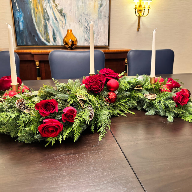 Modern holiday centerpiece featuring cedar, juniper, noble fir, and three candle spaces