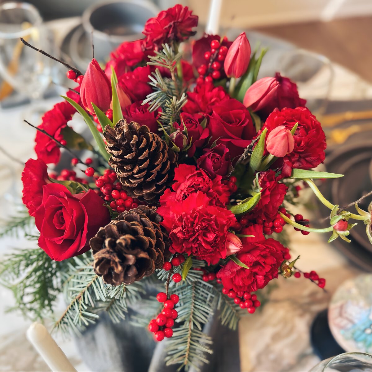 Bouquet of red flowers with pinecones