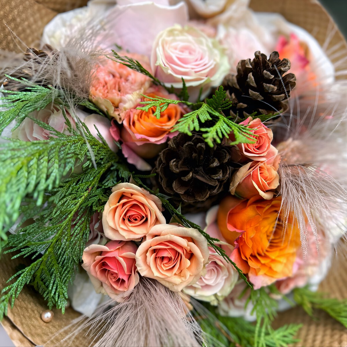 Bouquet with roses and pinecones