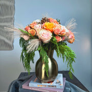 Peach and pink roses bouquet in a vase