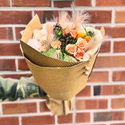 Peach and pink roses bouquet wrapped in Kraft paper
