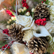 Close Up of the bouquet with pinecones and callas. 