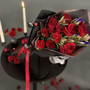 red roses in black paper.