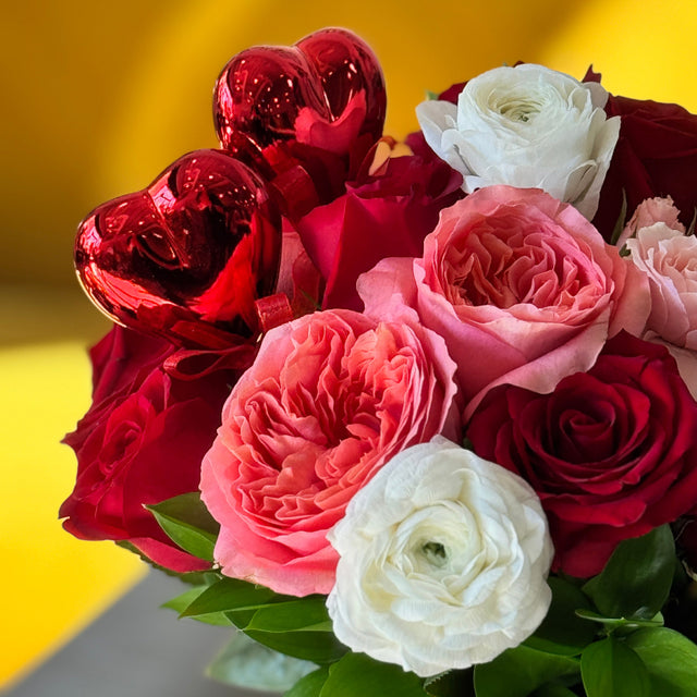 Romantic Valentine’s bouquet with pink expression roses, ranunculus, and red roses