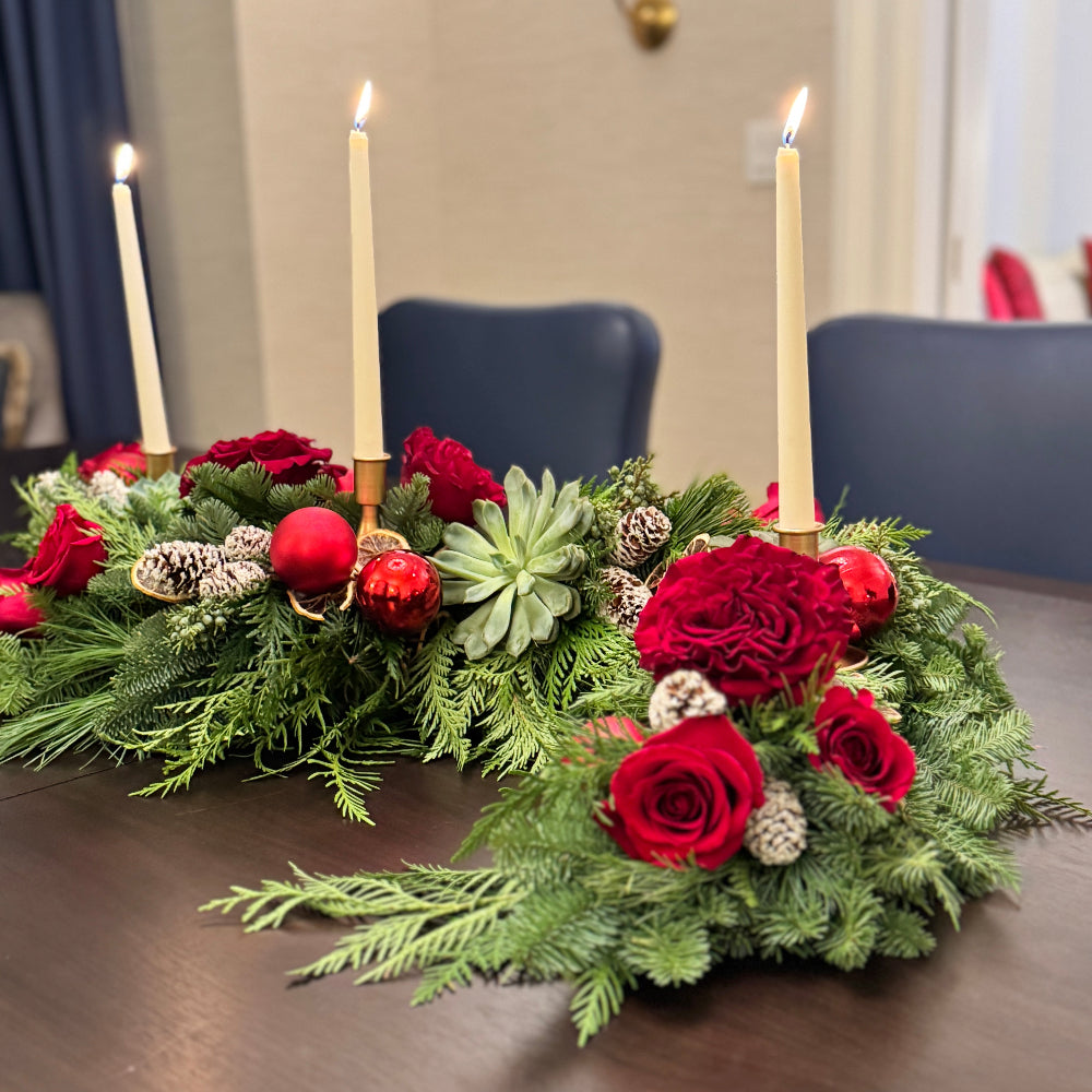 Sculptural evergreen centerpiece with succulents, pinecones, and dried lemon accents