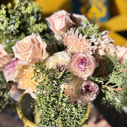 Seasonal holiday flower centerpiece with juniper, carnations, and mums